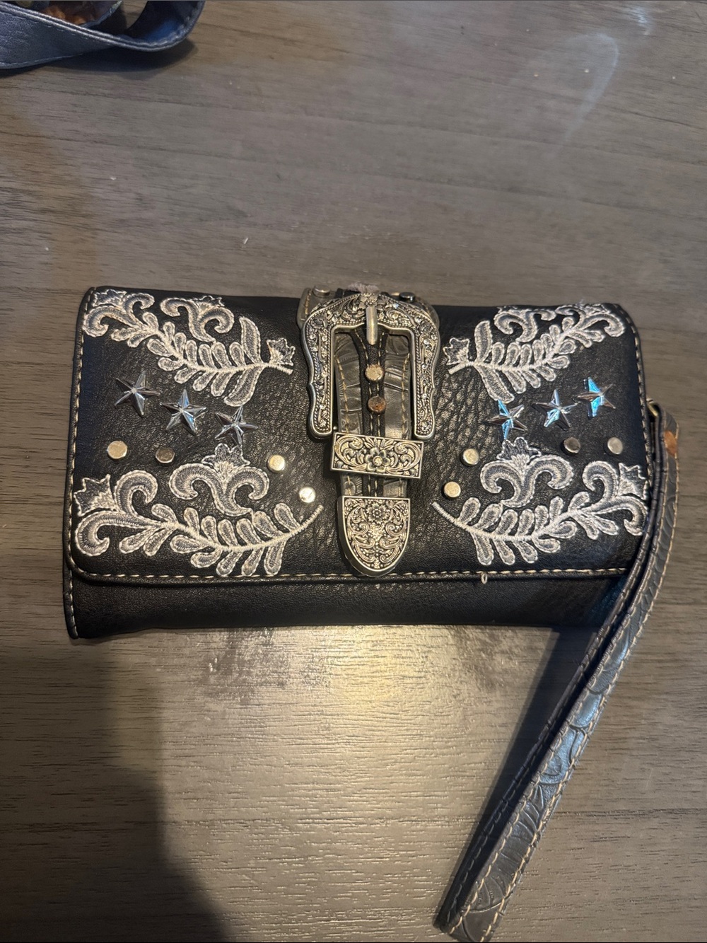 Embroidered Black Western Clutch wallet with Decorative Buckle and wrist strap.